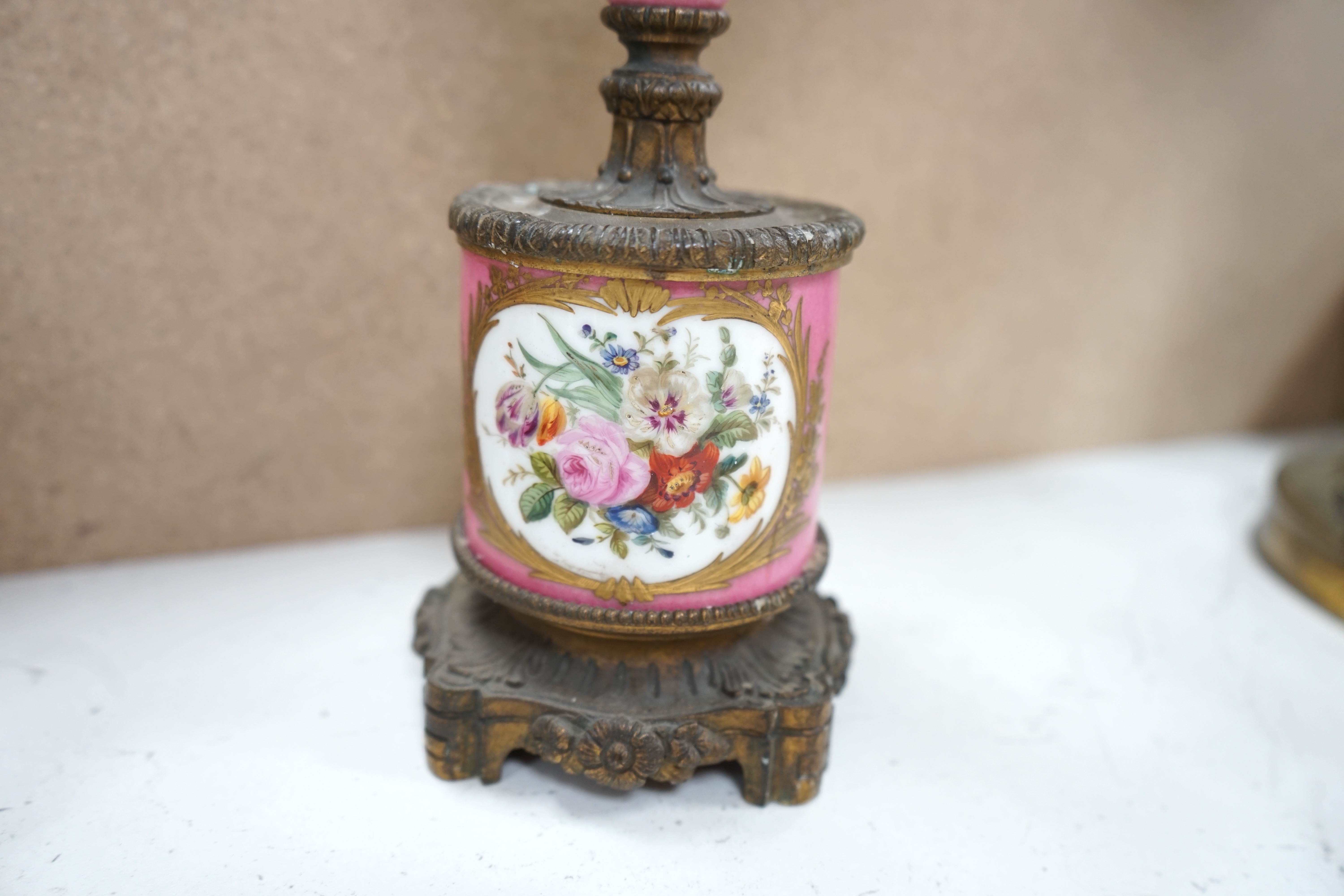 A pair of French porcelain mounted gilt metal candelabra and one other pair, tallest 45cm. Condition - fair